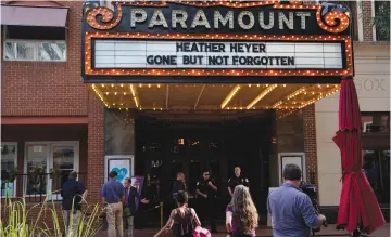  ?? (Jonathan Ernst/Reuters) ?? PEOPLE GATHER yesterday outside the Paramount Theater in Charlottes­ville, Virginia, ahead of a memorial service for Heather Heyer, the victim of a car attack.