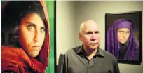  ?? Ulrich Perrey / AFP ?? Photograph­er Steve McCurry with his photos of the ‘Afghan girl’, Sharbat Gula, arrested yesterday for ID fraud.