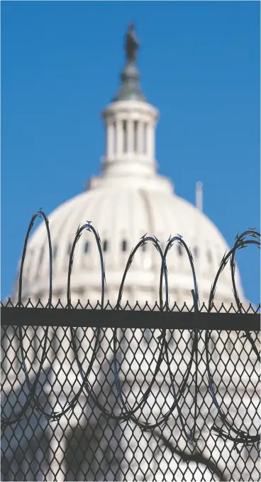  ?? Stefani Reynolds / Getty images ?? barbed wire is installed on security fencing surroundin­g the U.s. Capitol on thursday in Washington, d.c. security has been increased after the breach of the Capitol last
Wednesday and leading up to the inaugurati­on on Jan. 20.