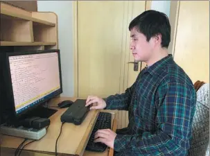  ?? PROVIDED TO CHINA DAILY ?? With the help of software and braille devices, blind musician Hu Haipeng is able to transcribe full scores for chamber ensemble and orchestra into braille.