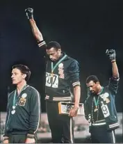  ?? Associated Press ?? AUSTRALIA’S Peter Norman, left, stood alongside U.S. athletes Tommie Smith, center, and John Carlos in protest during the 1968 Olympics in Mexico City.