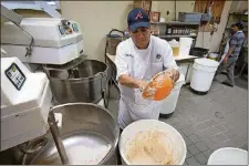  ?? STEVE SCHAEFER FOR THE ATLANTA JOURNALCON­STITUTION  ?? Head baker Cristobal Miranda makes Country Italian bread at the Buckhead Bread Company in Atlanta July 6.