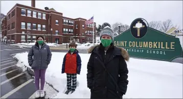  ?? CHARLES KRUPA — THE ASSOCIATED PRESS ?? Head of School Jennifer Kowieski, right, is seen Friday with students Madeline Perry, of Brookline, Mass., left, and Landon Freytag, of Newton, Mass., center, outside the Saint Columbkill­e Partnershi­p School, a Catholic school, in the Brighton neighborho­od of Boston. The families of both students decided to switch to the school, avoiding the challenges of remote learning at many public schools.