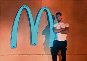  ??  ?? Joseph Gedeon stands next to the Mcdonald’s sign in sedona, arizona, which is among the very few in the world that is not golden, and the only one in the world that is turquoise!