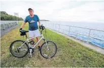  ?? RICARDO RAMIREZ BUXEDA/ORLANDO SENTINEL ?? Leon Konieczny, who often bikes on the RiverWalk trail, looks forward to riding on the new segment. “It’s going to be beautiful,” he said.