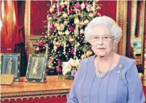  ??  ?? Royal address: Queen Elizabeth poses for a photograph as she stands in the State Dining Room of Buckingham Palace, after recording her Christmas Day television broadcast to the Commonweal­th.