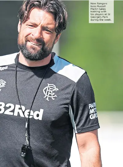  ?? ?? New Rangers boss Russell Martin takes training with his players at St George’s Park during the week.