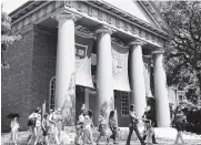  ?? AP FILE PHOTO BY ELISE AMENDOLA ?? A tour group walks through the campus of Harvard University in Cambridge, Mass.