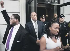  ?? Matt Rourke Associated Press ?? AFTER the judge’s announceme­nt of a mistrial, Bill Cosby listens as aide Ebonee Benson reads a statement from his wife outside the courthouse in Norristown, Pa.