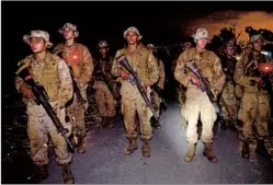  ??  ?? Recruits march back to their sleeping area for a brief rest before taking on the e 10-mile Reaper hike, the most difficult part of their training at Camp Pendleton.