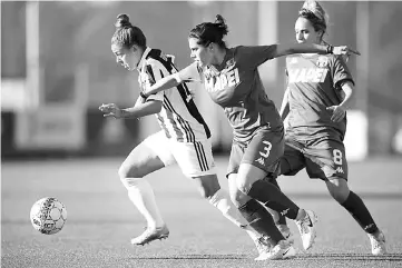  ??  ?? This file photo taken on Nov 18 shows Juventus’ midfielder Martina Rosucci (left) fighting for the ball with Sassuolo’s defender Giulia Bursi (centre) during the Women’s Italian football match between Juventus and Sassuolo at Juventus Centre in Vinovo....