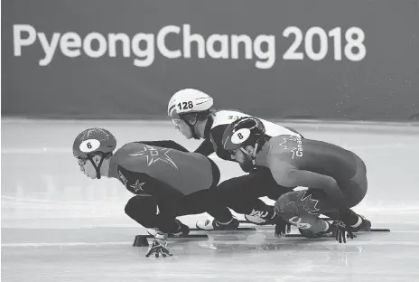  ?? ROBERTO SCHMIDT/AFP/GETTY IMAGES ?? China’s Wu Dajing, France’s Sebastien Lepape and Canada’s Charles Hamelin compete in a men’s 1,000-metre short-track speedskati­ng heat Tuesday at Gangneung Ice Arena. Hamelin and the 5,000-metre relay team, meanwhile, advanced Tuesday to the final.