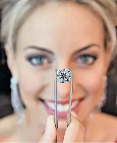  ??  ?? Queensland Diamonds netball captain Laura Geitz with a 12-carat De Beers diamond in Brisbane