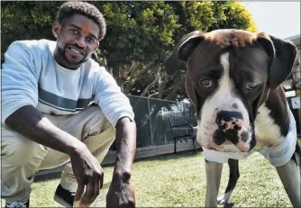  ?? RICHARD VOGEL — THE ASSOCIATED PRESS ?? Ro Mantooth plays with his dog, Champ, at a dog park with the nonprofit People Assisting the Homeless, in the Venice section of Los Angeles. It was the first facility of its kind in Los Angeles County to allow homeless shelter residents to bring animal companions. “He’s really my best friend. I don’t know what I’d do without him,” Mantooth, 29, said of Champ. “I’m lucky to have him. Not a lot of places are going to take animals, you know.”