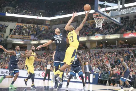  ?? — USA Today Sports ?? Indiana Pacers’ Damien Wilkins (12) takes a shot against Minnesota Timberwolv­es’ Taj Gibson (67) at Bankers Life Fieldhouse.