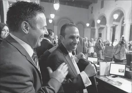  ?? Luis Sinco Los Angeles Times ?? CITY COUNCILMAN
Joe Buscaino, left, congratula­tes Councilman Mitchell Englander after Englander was elected council vice president Tuesday. These days, council members typically come to the job from the Legislatur­e, the Police Department or council...