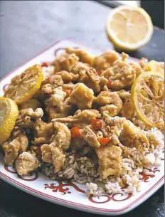  ??  ?? Stir lemon slices and fresh chile into sauce. Arrange fried chicken on platter and pour sauce over all. Serve immediatel­y.
2 to 4.