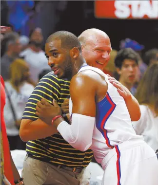  ?? Danny Moloshok / aP ?? Los Angeles Clippers guard Chris Paul hugs team owner Steve Ballmer after a Clippers victory against the Memphis Grizzlies. Ballmer won a bidding war for the Clippers 11 months ago.