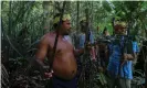  ?? Photograph: Ricardo Oliveira/AFP/ ?? Sateré-Mawé men collect medicinal herbs to treat people showing Covid symptoms, in a rural area west of Manaus, Brazil.