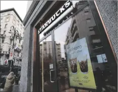  ?? ANTONIO CALANNI/AP ?? A STARBUCKS SIGN advertises the company’s Oleato coffee in one of their coffee shops in Milan, Italy, on Monday.