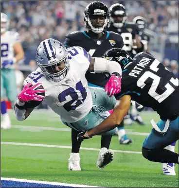  ?? GETTY IMAGES ?? Dallas Cowboys’ Ezekiel Elliott dives into the end zone against Jacksonvil­le Jaguars defender Tyler Patmon for a touchdown during yesterday’s blowout win.