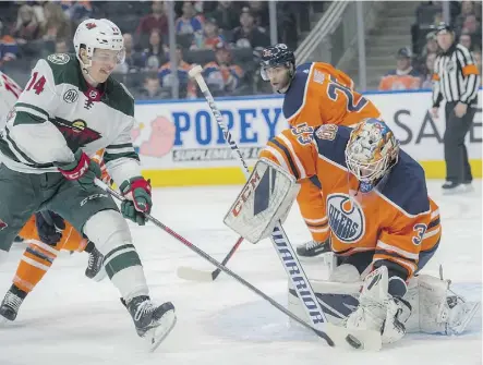  ?? SHAUGHN BUTTS ?? Oilers goalie Cam Talbot foils Joel Eriksson Ek of the Minnesota Wild Friday night at Rogers Place. Talbot was making his second consecutiv­e start for the first time since the end of October.