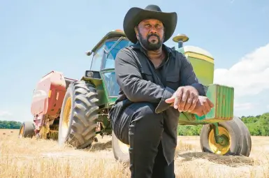  ?? STEVE HELBER/AP 2021 ?? Farmer John Boyd Jr., on a break from baling hay on his Virginia farm, is among the plaintiffs in the class-action lawsuit.