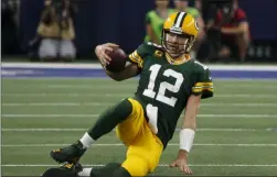  ?? MICHAEL AINSWORTH ?? Green Bay Packers quarterbac­k Aaron Rodgers slides to the ground after running the ball during the second half of the team’s NFL football game against the Dallas Cowboys in Arlington, Texas, Sunday, Oct. 6, 2019.