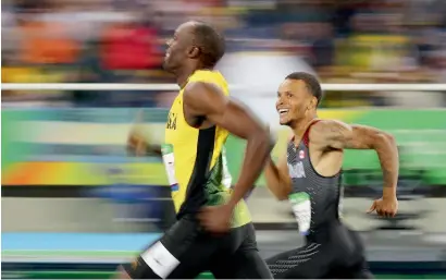  ?? Reuters file ?? Usain Bolt of Jamaica (left) and Andre De Grasse of Canada smile as they finish Rio Olympic 200m race. —