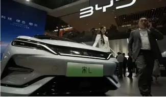  ?? ?? A model poses near the BYD Song L EV car during Auto China 2024 held in Beijing, Thursday, April 25, 2024.