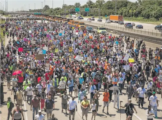  ?? ASHLEE REZIN/ SUN- TIMES ?? Anti- violence protesters pour into the inbound lanes of the Dan Ryan Expressway on Saturday morning.