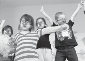  ?? RACHEL PSUTKA/Leader-Post ?? Wascana School kindergart­en students Gemma-Jean Oakes, front, Emma Cote, back left,
Kyla Kahnapace and Dawson Moffatt rehearse for their Christmas concert on Dec. 17.