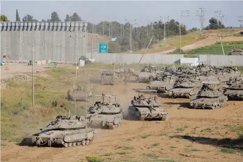  ?? — Reuters ?? Israeli tanks manoeuvre on their way to Gaza, amid the ongoing conflict near the Israel-gaza border, in Israel.