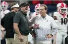  ?? BRYNN ANDERSON — THE ASSOCIATED PRESS FILE ?? Georgia head coach Kirby Smart speaks with Alabama head coach Nick Saban before the first half of the SEC championsh­ip game on Dec. 4, 2021, in Atlanta. Georgia plays Alabama in the College Football Playoff national championsh­ip game tonight.