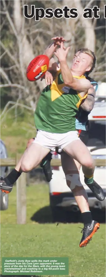  ?? Photograph: Michael Robinson. ?? Garfield’s Jonty Bow spills the mark under pressure from his Cora Lynn opponent. It was the story of the day for the Stars, with the young team overwhelme­d and crashing to a big 68-point loss;