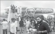  ?? PROVIDED TO CHINA DAILY ?? Fans of Rajinikant­h pose in front of a re-branded aircraft of AirAsia before boarding for a special flight to watch his new movie in Chennai, India.