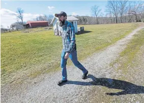  ??  ?? Nic Talbott walks from his house to his grandmothe­r’s in Lisbon, Ohio, on Friday.