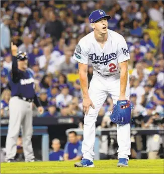  ?? Wally Skalij Los Angeles Times ?? DODGERS STARTER Walker Buehler watches a two-run home run by Orlando Arcia in the seventh inning as Milwaukee third base coach Ed Sedar signals that the ball is gone.
