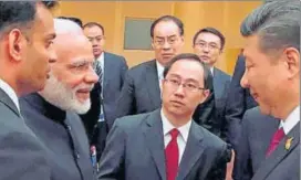  ?? PTI FILE PHOTO ?? Prime Minister Narendra Modi and Chinese President Xi Jinping exchange greetings at the BRICS leaders' informal gathering in Hamburg, Germany.