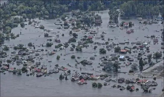  ?? DANIEL BEREHULAK — THE NEW YORK TIMES ?? An aerial view of floodwater­s from the collapse of the Kakhovka dam, along the Dnipro River in Kherson, Ukraine, on June 10. Floodwater­s are receding nearly two weeks after the disaster, but officials are grappling with a new concern: the potential for outbreaks of waterborne diseases.