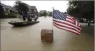  ?? DAVID J. PHILLIP — THE ASSOCIATED PRESS ?? Volunteers use their boat to help evacuate residents as floodwater­s from Tropical Storm Harvey rise Monday in Spring, Texas.