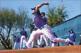  ?? Ross D. Franklin Associated Press ?? CLAYTON KERSHAW wants to pitch in the World Baseball Classic but there are “challenges” getting him cleared, U.S. general manager Tony Reagins says.