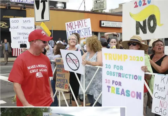  ?? NICOLAUS CZARNECKI PHOTOS / HERALD STAFF ?? RALLY TIME: A Trump supporter walks past protesters gathered outside the president’s rally at the SNHU Arena in Manchester, N.H., on Thursday. Left, a supporter argues with Jeanie Hanczarek in the crowd, and supporters use a flag to block off protesters. below.