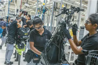  ?? ATUL LOKE/THE NEW YORK TIMES ?? Workers build scooters Aug. 24 at an Ola Electric factory in the southern Indian state of Tamil Nadu.