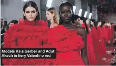  ??  ?? Models Kaia Gerber and Adut Akech in fiery Valentino red
