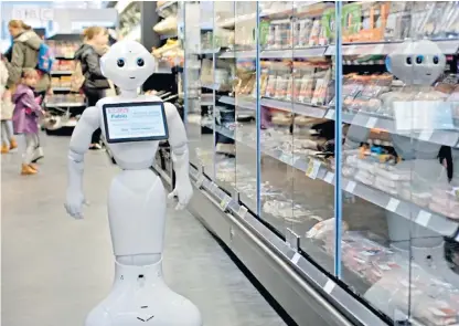  ??  ?? Robo-shop: Fabio, the robotic shop assistant, in the aisles of a Margiotta supermarke­t. It was said to have alarmed customers, who were careful to avoid it