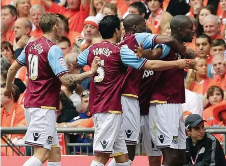  ??  ?? Big time: West Ham’s Carlton Cole (right) celebrates with team-mates after scoring against Blackpool during their Division Two playoff final at Wembley on Saturday. — Reuters