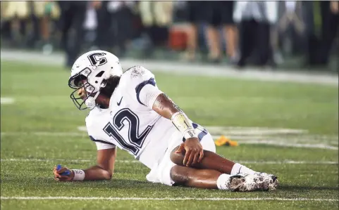  ?? Matthew Maxey / Icon Sportswire via Getty Images ?? UConn QB Tyler Phommachan­h holds his leg after suffering an injury at Vanderbilt on Saturday in Nashville.