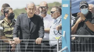  ??  ?? 0 Israeli Prime Minister Benjamin Netanyahu visits the scene of the tragedy