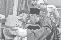  ?? — Gambar Bernama ?? RESTU: Aminuddin (kanan) mengusap pipi ayahnya Harun sebagai tanda memohon restu selepas mengangkat sumpah sebagai Menteri Besar di Kampung Pachitan Chuah dekat Port Dickson, semalam.